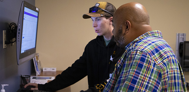 IT Support personnel assisting student